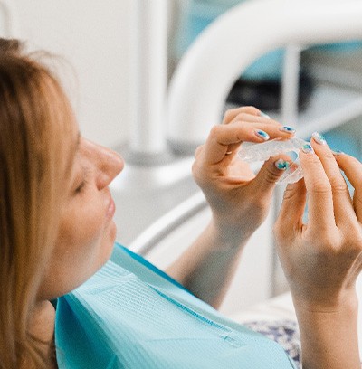 Closeup of patient holding clear aligner