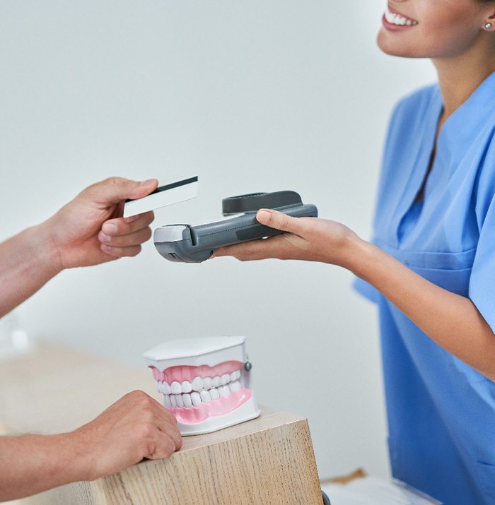 Patient paying for treatment with credit card in lobby