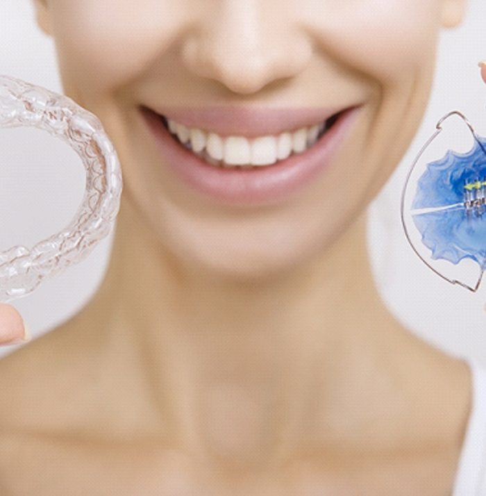 Woman using retainers for Invisalign aftercare in Kansas City, MO