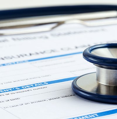 Stethoscope lying on health insurance form