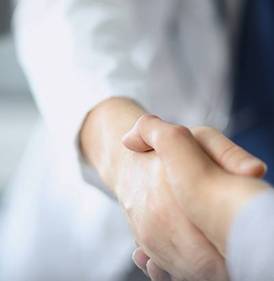 Dentist shaking hands with patient