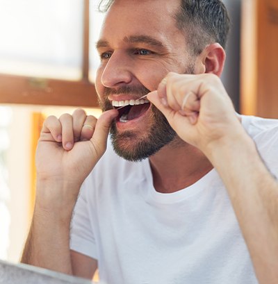 Man flossing his teeth