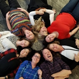 Kansas City dental team laying on floor in circle
