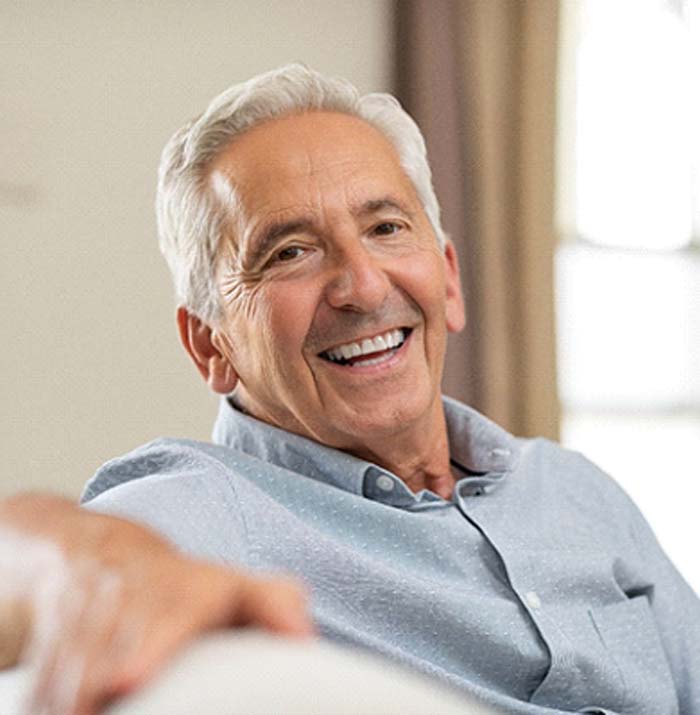 patient smiling after getting dental implants in Kansas City