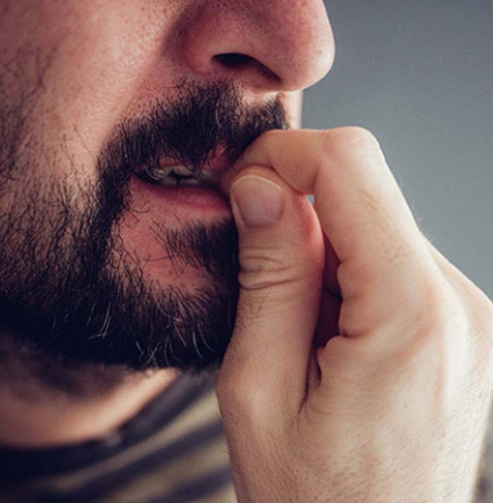 man biting fingernails