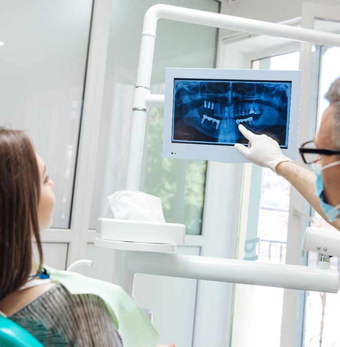 dentist showing a patient their dental X-rays