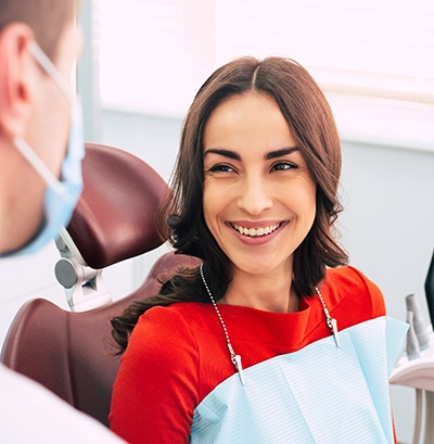 Woman smiling at dentist in treatment room
