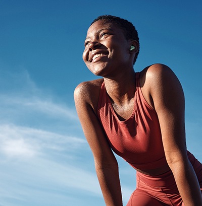 Woman smiling while exercising outside