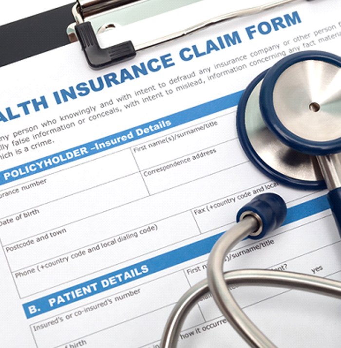 Health insurance claim form on clipboard, under stethoscope