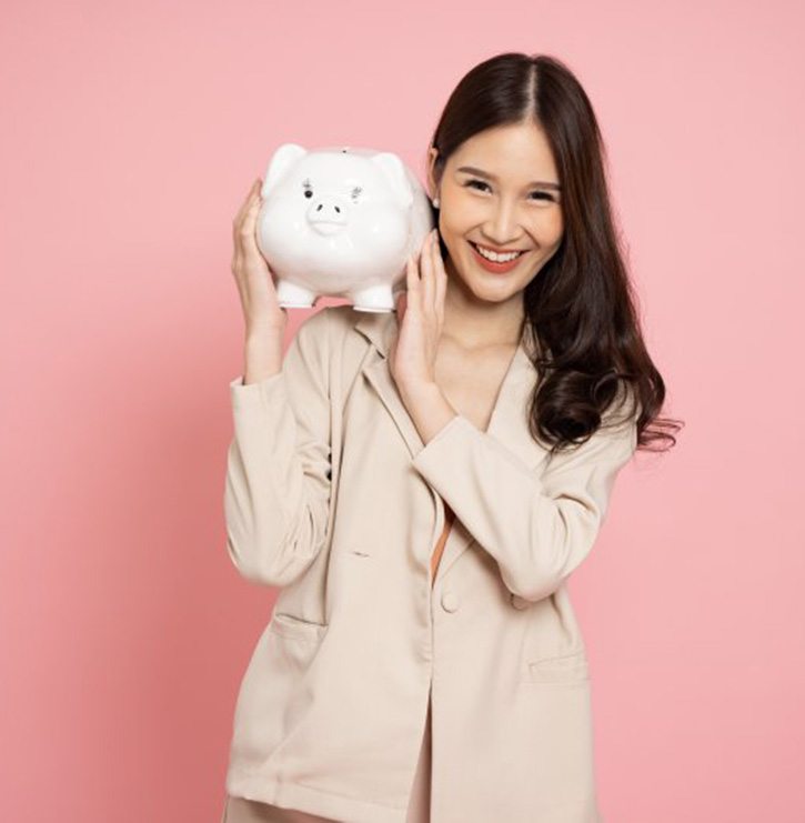 Woman holding a piggy bank and smiling