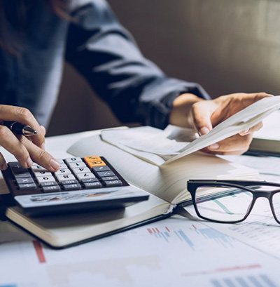 Person using a calculator at their desk