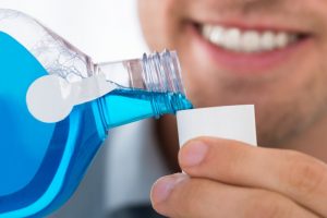 A person using mouth wash for their oral healthcare.