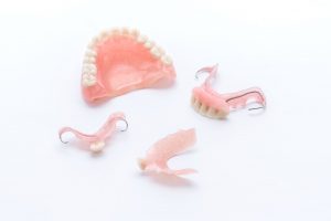 Full and partial dentures on white background