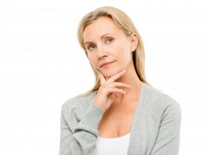 woman contemplating Invisalign vs. braces