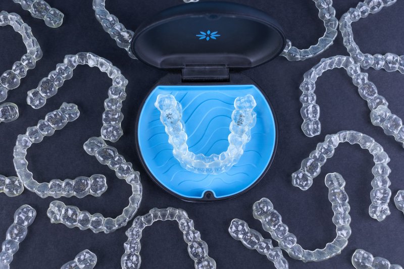 plastic case surrounded by Invisalign aligners