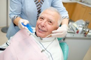 older man with dental implants in Kansas City