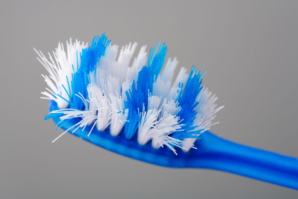 Closeup of frayed blue toothbrush