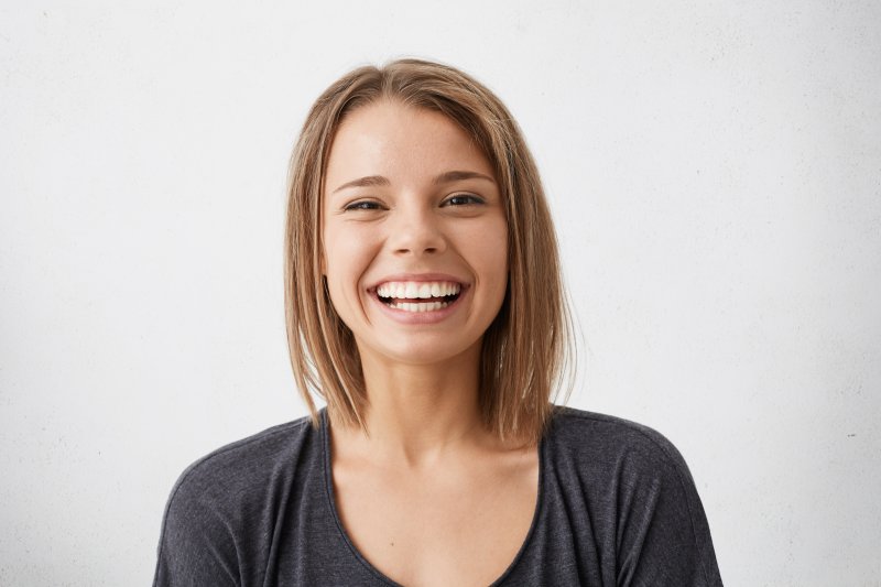 smiling patient after getting a smile makeover