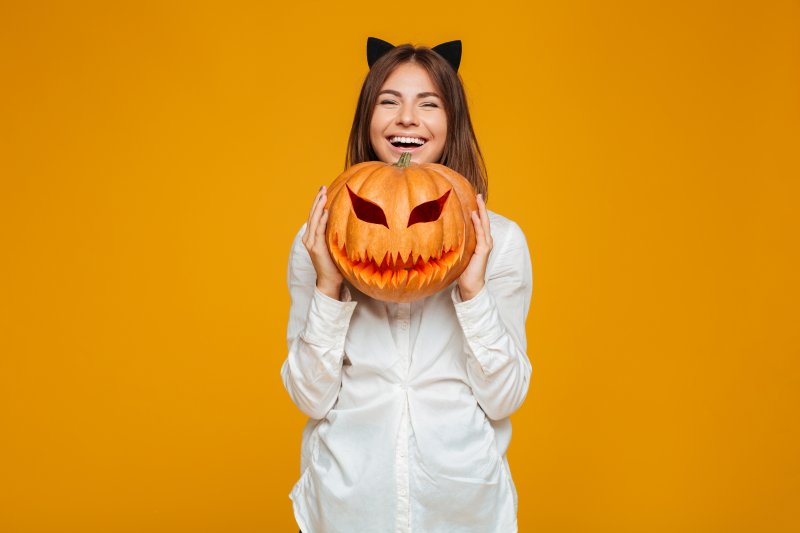 a woman smiling after visiting a dentist in Kansas City