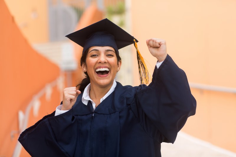 A closeup of a student celebrating their college graduation