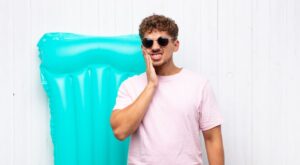 Man with a dental emergency during his summer vacation